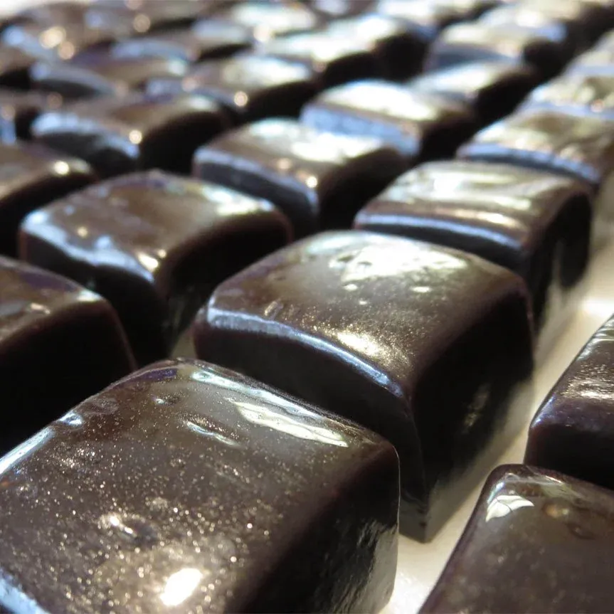 Rows of glossy, freshly cut chocolate caramels