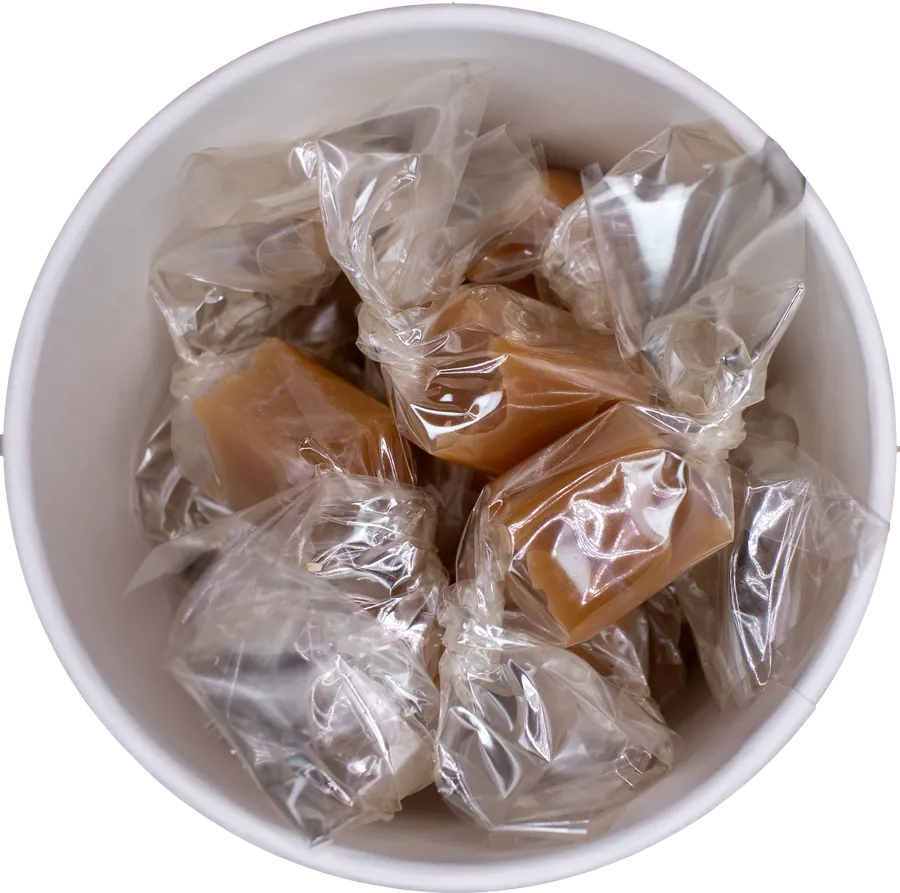 A tub of Cheryl's Caramels seen from above, filled with wrapped caramels